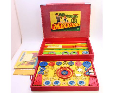 Meccano outfit no.9, comprising red, blue and green components, such as boilers, wheels, crown gears, and others, all mounted
