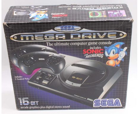 Sega Mega Drive original boxed console comprising of a console, a power lead, 2 control pads, and a boxed Sonic the Hedgehog 