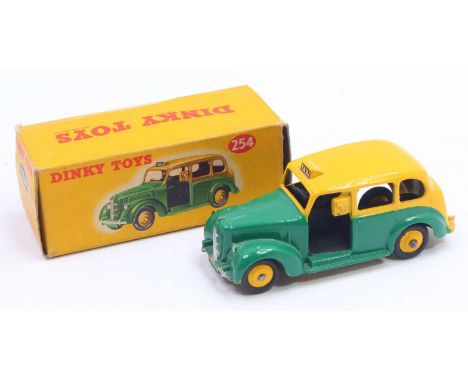 Dinky Toys No. 254 Austin Taxi comprising a yellow and green body with yellow hubs in the original correct colour spot all-ca