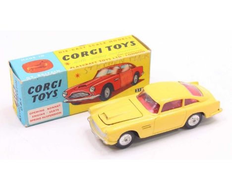 Corgi Toys No. 218 Aston Martin DB4, finished in yellow with red interior and silver hubs, housed in the original blue &amp; 