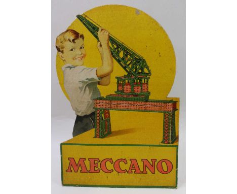 Meccano promotional card sign, depicting a boy playing with a large Meccano gantry crane. The sign has lost some colour and h