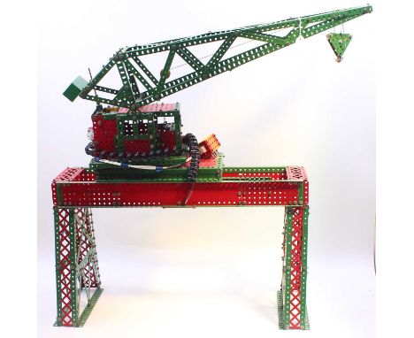 A large, made-up Meccano model of a Topliss Luffing crane, built from red and green components, with motors for the boom and 