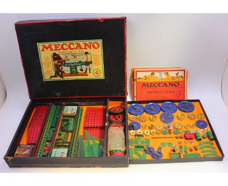 Meccano outfit no.4 containing blue, green and red components, with the boiler, housed in the original box, with instructions