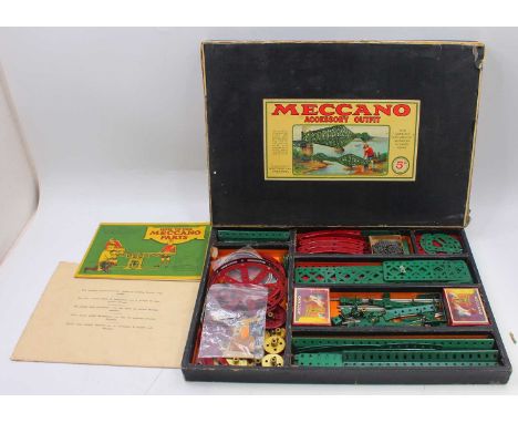 1932 Meccano accessory outfit 5a, comprising red and green components, with brass gears, housed in the original black card bo