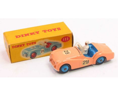 Dinky Toys No. 111 Triumph TR2 sports car comprising a salmon pink body with blue interior and hubs, with driver figure in th