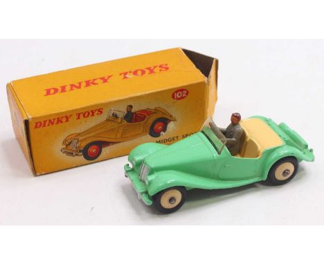 Dinky Toys No. 102 MG Midget sports car comprising a light green body with cream interior, cream hubs and driver figure, in t