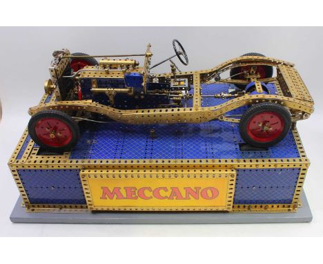 A large, made-up Meccano model of a Bentley 3.5-litre sports car chassis, constructed from blue and gold components, on an el
