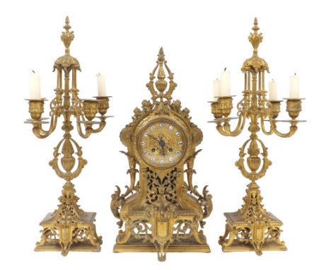 French ornate gilt metal two train mantel clock garniture, the movement striking on a bell, the 4" gilt metal dial with Roman