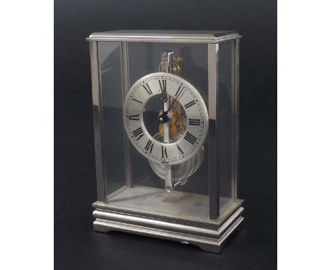 Jaeger LeCoultre small mystery desk clock timepiece, the 1.75" silvered chapter ring enclosing a skeletonised centre with in-