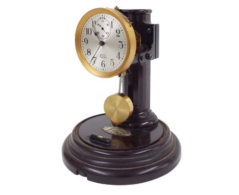 Poole electric mantel clock, the 3" silvered dial with subsidiary seconds dial, supported upon a Bakelite column and circular