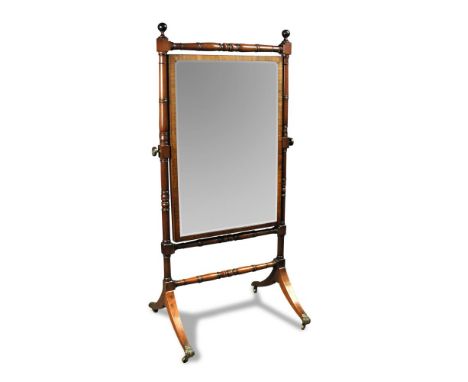 A Regency mahogany cheval mirror, with ring turned column uprights and stretchers, on splayed legs with brass claw casters 16