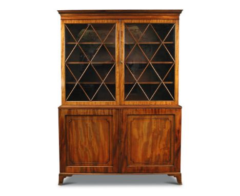 A Regency style mahogany bookcase, with Greek key moulded cornice, astragal glazed doors above panel doors to the base, on sw
