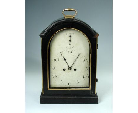 A George III ebonised bracket clock, the break arch case with handle above 8inch (20cm) painted dial, with strike silent to t