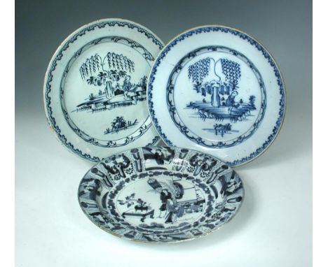 An 18h century Delft blue and white charger, painted to the centre with a boy standing beneath a willow tree, 35cm (13.75in) 