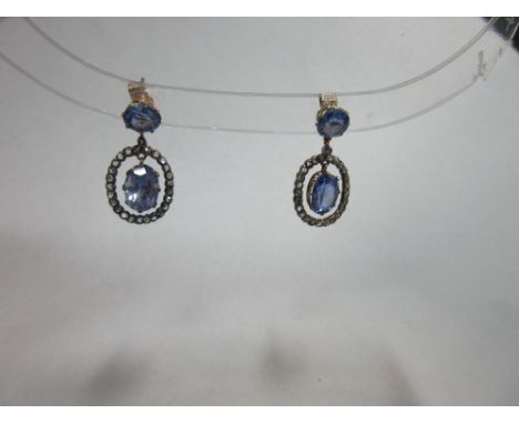 A pair of light blue sapphire and diamond pendant earrings, each post headed by a round cut light lavender blue sapphire susp