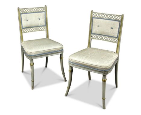 A pair of parcel gilt grey painted salon chairs, on swept ring tuned legs, one with Royal Household branded stamp and another