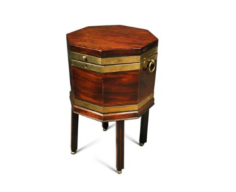 A George III mahogany octagonal wine cooler, brass bound with ring handles, on a stand with moulded square legs and casters 7