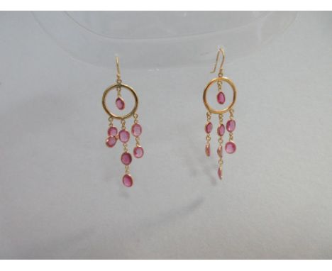 A pair of pink tourmaline earpendants, from each hook fitting hangs a ring in which is suspended an oval cut pink tourmaline 