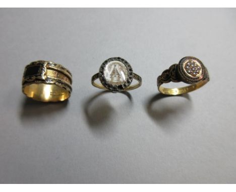 Three 18th and 19th century mourning rings, the first with an oval ivory plaque painted en grisaille with a memorial monument