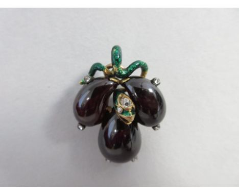 A 19th century fruit and snake pendant, designed as a cluster of three cabochon pear-shaped garnet fruits with rose cut diamo