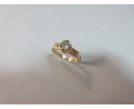 A fancy coloured diamond single stone and 18ct gold ring, the round brilliant cut light golden brown diamond, estimated weigh