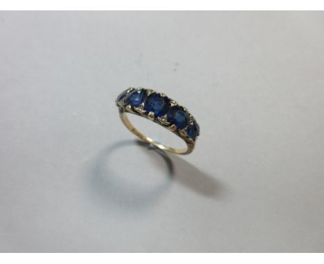 An antique five stone sapphire ring with diamond highlights, the graduated oval cut sapphires claw set with rose cut diamond 