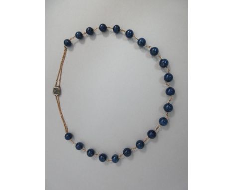 A lapis lazuli bead necklace with a Georgian seed pearl clasp, the 12mm beads with short chain connections to a double back c