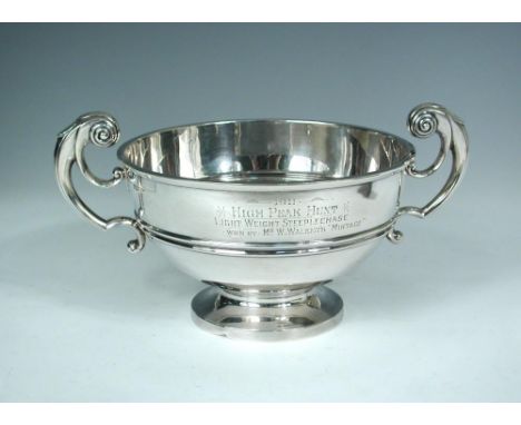 An Edwardian silver two handled trophy cup, by Walker & Hall, Sheffield 1910, of shallow circular form with moulded girdle, e