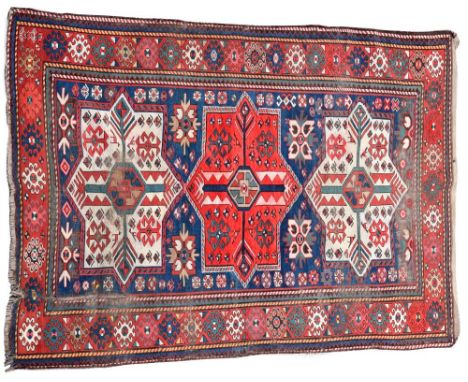 An early 20th century Kazak rug, 240 x 125cm (94 x 49in)  An old rug with evidence of very low pile and wear, some colour run