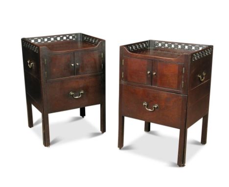 A pair of early George III mahogany night tables, with trellis and florette carved galleries, cupboards and drawers, lacking 