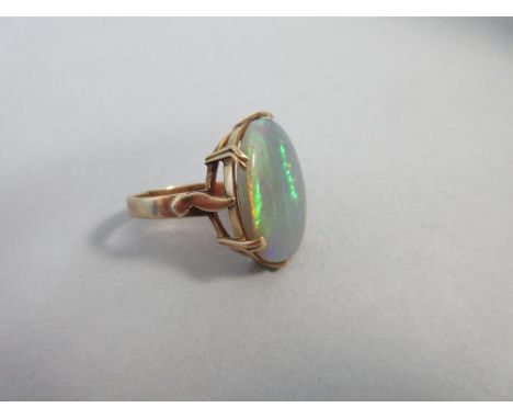 A large single stone Australian opal ring, the oval shallow cabochon opal, measuring 9.2 x 6.5 x 5.0mm, abraded but showing a