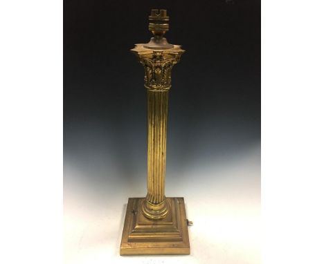 A brass column table lamp, the Corinthian capped reeded column to a stepped square base 52cm (20in)  