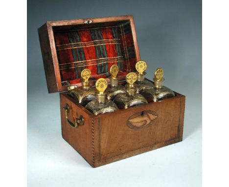 A 19th century mahogany decanter box with six gilt glass decanters, the front with shell and geometric inlays, brass handles 