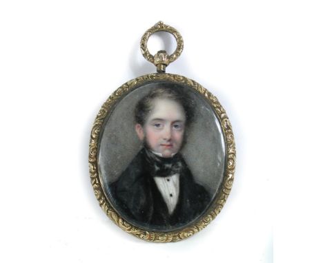 Circle of William Egley (1789-1870) A miniature portrait of a young gentleman in a gilt metal frame with curled hair compartm