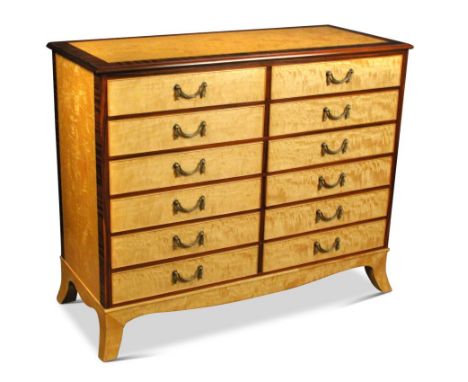 A modern satinwood chest of drawers, crossbanded with Indian santos rosewood, fitted two banks of six small drawers with cast