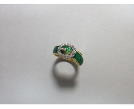 An 18ct gold, diamond and enamel buckle ring, the front of the band and tongue of the garter with green guilloche enamel, the