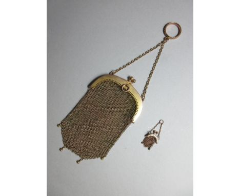A Continental gold mesh evening purse together with a miniature example, the arched hinged snap suspending the mesh bag with 