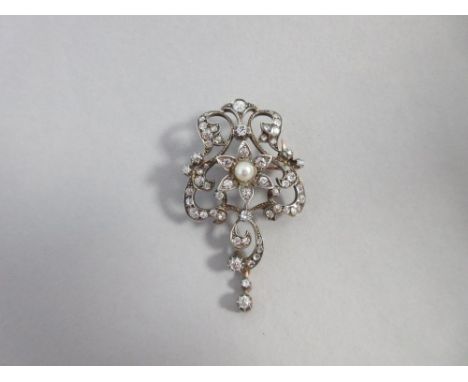 A late 19th century diamond and pearl brooch in the Art Nouveau taste, designed as an open scrolling lyre form set throughout