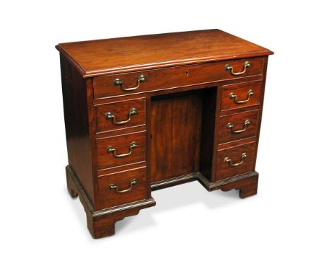 A George III mahogany kneehole desk, fitted one long drawer, central cupboard and three small drawers, on bracket feet 75 x 8