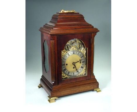 A late Victorian mahogany chiming table clock, the traditional shape case with folding gilt handle above 19cm brass dial havi