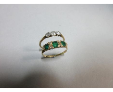 An 18ct gold emerald and diamond ring together with a diamond three stone ring, the first with three graduated oval step cut 