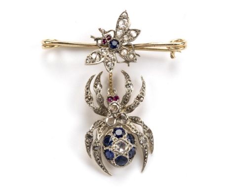 A diamond and gem set spider and fly brooch, designed as a short pin brooch on which rests a fly with diamond set wings, a sa