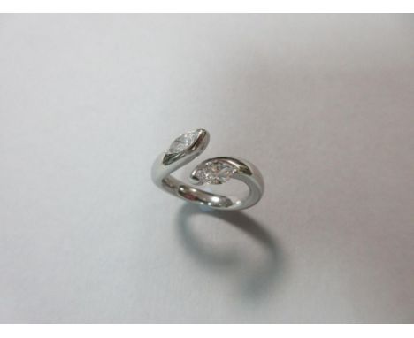 A two stone marquise cut diamond ring set in platinum, the open crossover design with a marquise cut diamond part rubover set