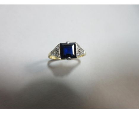 An Art Deco sapphire and diamond ring cased by Collingwood, the square step cut sapphire, not tested but showing faint straig
