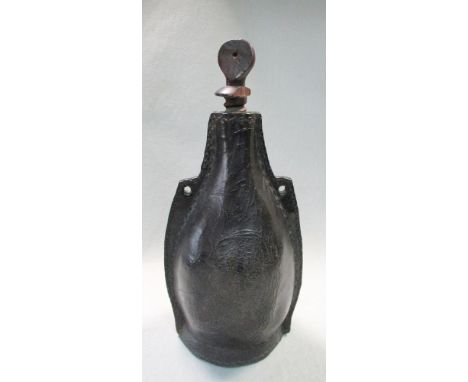 A leather Blackjack bottle flask, possibly 19th century, the stitched bottle with suspension loops to either side and a turne