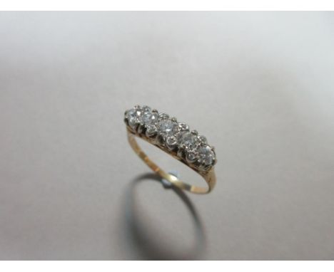 A diamond five stone ring with further diamond highlights, the five graduated round brilliant cut diamonds with four pairs of