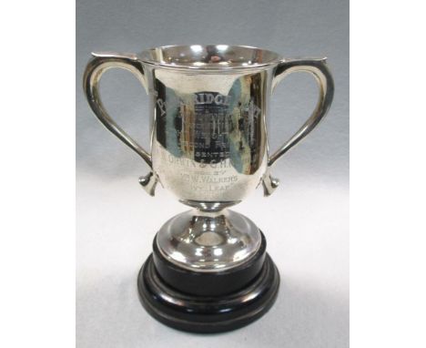 An Edwardian silver two handled pedestal trophy cup, by William Hutton & Sons, Sheffield 1909, of slight baluster form, engra