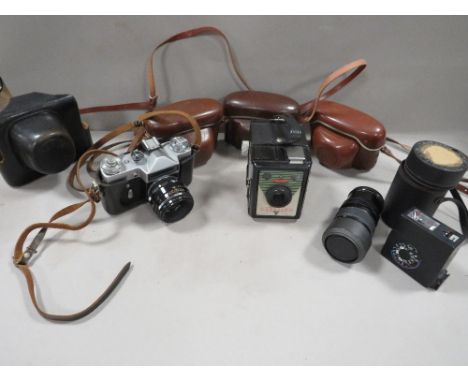 A tray of vintage cameras and lenses