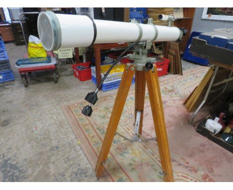 A vintage astronomical telescope on tripod stand