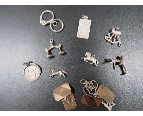 Nine vintage silver bracelet charms and a pair of 9ct gold on silver cufflinks